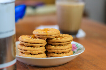 Breakfast and snack menu. Butter biscuits with pineapple jam and a glass of chocolate milk. Close-up of butter cookies and a glass of chocolate, sweet cakes. Perfect for recipes, articles, catalogs.