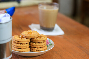 Breakfast and snack menu. Butter biscuits with pineapple jam and a glass of chocolate milk. Close-up of butter cookies and a glass of chocolate, sweet cakes. Perfect for recipes, articles, catalogs.
