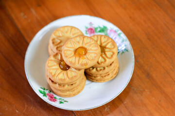 Breakfast and snack menu. Butter biscuits with pineapple jam and a glass of chocolate milk. Close-up of butter cookies and a glass of chocolate, sweet cakes. Perfect for recipes, articles, catalogs.
