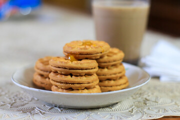 Breakfast and snack menu. Butter biscuits with pineapple jam and a glass of chocolate milk. Close-up of butter cookies and a glass of chocolate, sweet cakes. Perfect for recipes, articles, catalogs.