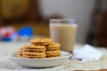Breakfast and snack menu. Butter biscuits with pineapple jam and a glass of chocolate milk. Close-up of butter cookies and a glass of chocolate, sweet cakes. Perfect for recipes, articles, catalogs.