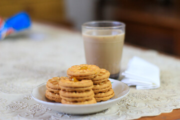 Breakfast and snack menu. Butter biscuits with pineapple jam and a glass of chocolate milk. Close-up of butter cookies and a glass of chocolate, sweet cakes. Perfect for recipes, articles, catalogs.
