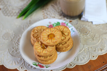 Breakfast and snack menu. Butter biscuits with pineapple jam and a glass of chocolate milk. Close-up of butter cookies and a glass of chocolate, sweet cakes. Perfect for recipes, articles, catalogs.