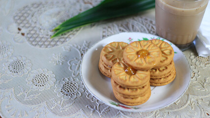 Breakfast and snack menu. Butter biscuits with pineapple jam and a glass of chocolate milk. Close-up of butter cookies and a glass of chocolate, sweet cakes. Perfect for recipes, articles, catalogs.