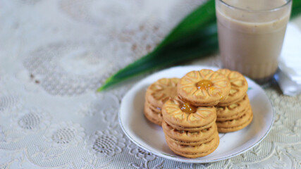 Breakfast and snack menu. Butter biscuits with pineapple jam and a glass of chocolate milk. Close-up of butter cookies and a glass of chocolate, sweet cakes. Perfect for recipes, articles, catalogs.