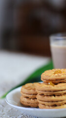 Breakfast and snack menu. Butter biscuits with pineapple jam and a glass of chocolate milk. Close-up of butter cookies and a glass of chocolate, sweet cakes. Perfect for recipes, articles, catalogs.