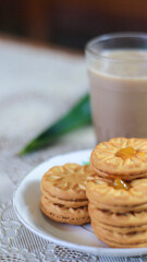 Breakfast and snack menu. Butter biscuits with pineapple jam and a glass of chocolate milk. Close-up of butter cookies and a glass of chocolate, sweet cakes. Perfect for recipes, articles, catalogs.