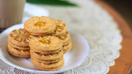 Breakfast and snack menu. Butter biscuits with pineapple jam and a glass of chocolate milk. Close-up of butter cookies and a glass of chocolate, sweet cakes. Perfect for recipes, articles, catalogs.