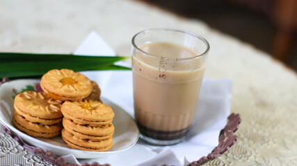 Breakfast and snack menu. Butter biscuits with pineapple jam and a glass of chocolate milk. Close-up of butter cookies and a glass of chocolate, sweet cakes. Perfect for recipes, articles, catalogs.