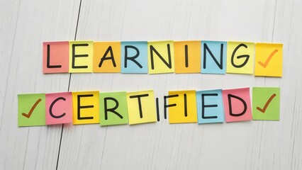 Fototapeta premium Colorful Sticky Notes Display of Learning and Certification Concepts on White Wooden Background