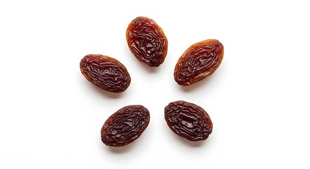 Five dried raisins arranged in a starburst pattern against a plain white background.