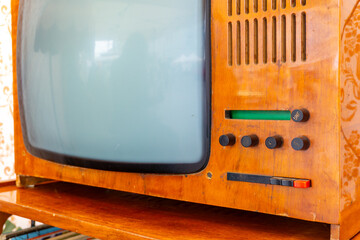 Vintage cathode-ray tube television in wooden casing, visible knobs and speaker grille, retro style, mid 20th century design.