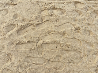 Footprints in Sand on Beach with Natural Lighting and Textured Surface