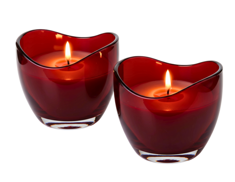Two red heart shaped glass candle holders with lit candles isolated on transparent background