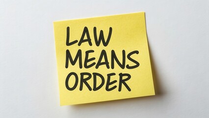 Creative reminder note with the phrase Law Means Order written in bold black letters on a yellow sticky note against a white background