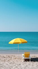 Yellow beach umbrella and lounge chair on sandy shore
