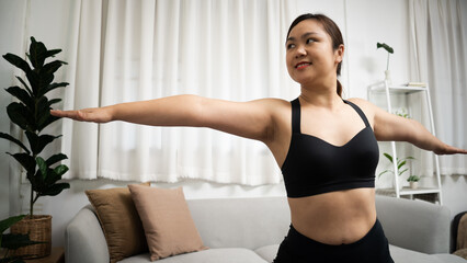 Female happiness Attractive young asian woman doing yoga stretching exercise on mat yoga Calmness and relax at home