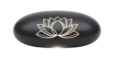 Black stone with a glowing lotus flower design. Spa, zen, and meditation concept.