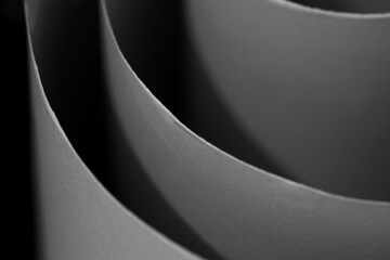 Abstract black and white background of elegant, flowing curves. Soft light and shadow create a minimalist and modern design with a sense of rhythm.