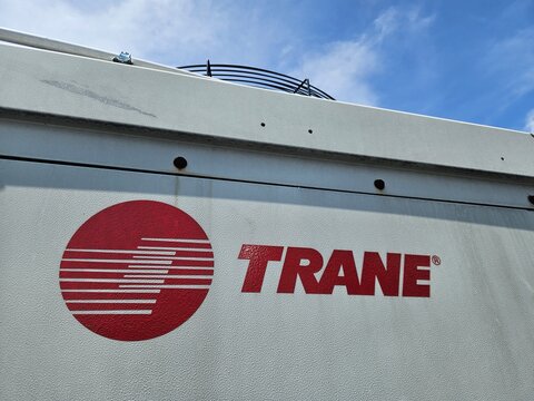 Large outdoor industrial cooling unit "Trane" with a visible fan against a clear blue sky On September 15, 2025 in Bandung, Indonesia