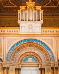 Synagogue interior with intricate details and grand organ.