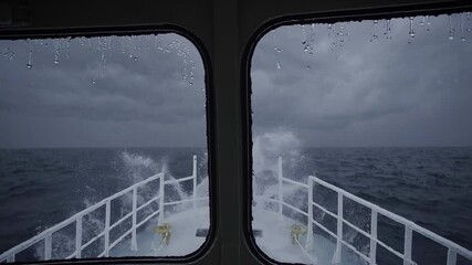 Captain's cabin view of a ship sailing through a turbulent sea during a violent storm, with large waves splashing against the vessel's bow and rain dripping down the windows - Powered by Adobe