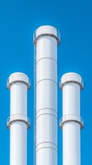 Low angle cinematic shot of futuristic Power Plant Emissions Scrubbers with pipes and ducts against clear blue sky. 