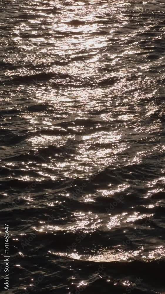 Poster a shimmering surface of water reflecting sunlight, creating a sparkling effect