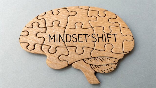 Wooden puzzle brain piece with the phrase Mindset Shift symbolizing mental transformation and personal growth concept