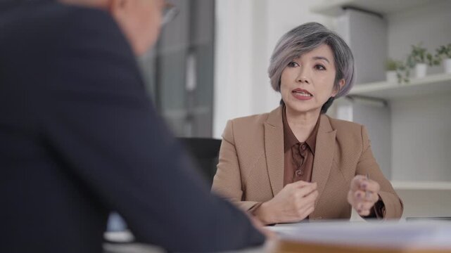 Asian adult woman professional discusses business office consultant gives expert advice serious meeting