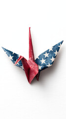 Obraz premium A red and blue origami crane decorated with star patterns, symbolizing patriotism and creativity.