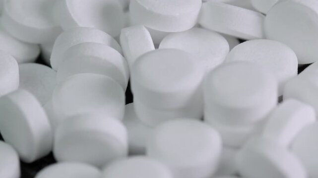 Sugar substitute pills rotating in macro. Artificial sweetener tablets zero calories