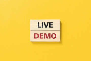 Live demo symbol. Concept words 'live demo' on wooden blocks on a beautiful yellow background. Copy space. Business and live demo concept.