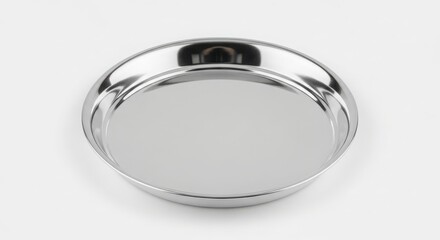 A shiny stainless steel plate with a raised rim, isolated on white background