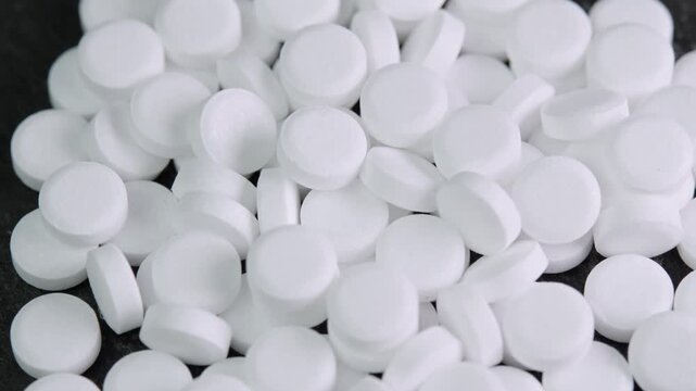 Sugar substitute pills rotating in macro top view. Artificial sweetener tablets zero calories