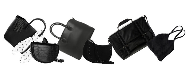 scattered black handbags on a black surface