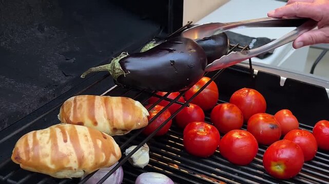 Man grilling vegetables on a warm summer day. Preparing the grill, flaming charcoal briquettes on a grill-grill, heating up the coals for a grill party.