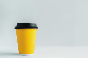 A yellow coffee cup on a plain background, suggesting a beverage for enjoyment.