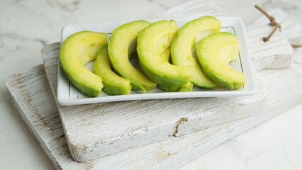 close up slices of avocado on chopping board. Selective focus