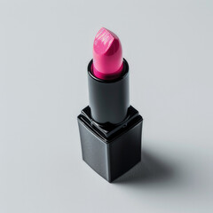 A vibrant pink lipstick in a sleek black case, showcasing beauty and cosmetic application.