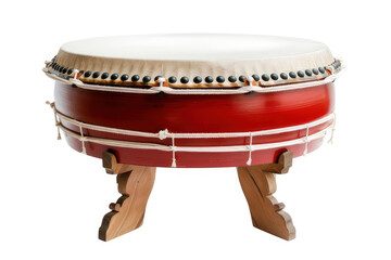 A traditional drum with a round, white top and red body, used in cultural music performances.