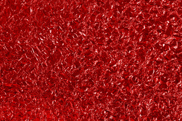 Dark red foil leaf shiny texture, abstract wrapping paper for background and design art work.