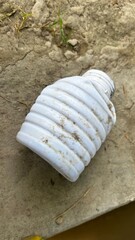 Plastic bottle in a Natural Setting: A weathered, discarded plastic bottle lies on the parched earth. The image evokes contemplation about waste and its pervasive impact.