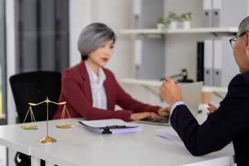 Asian adult lawyer woman advises client man professional legal business consultation office meeting...