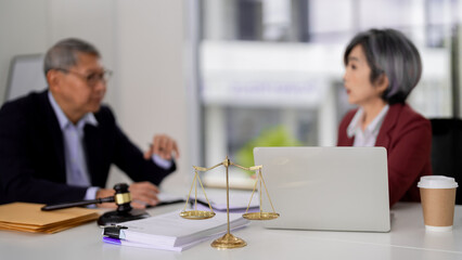 Asian legal professionals discussing client case justice scale gavel present law firm meeting office
