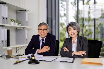 Experienced Asian legal professionals offer expert advice and solutions in a modern office fostering client trust and effective business counsel