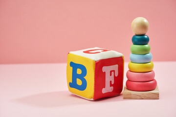 baby toys against pink background