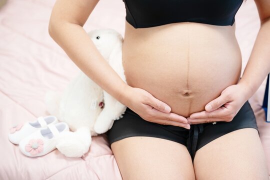 pregnant woman touches belly, Concepts of pregnancy and family. Place for text. Place for your advertisement