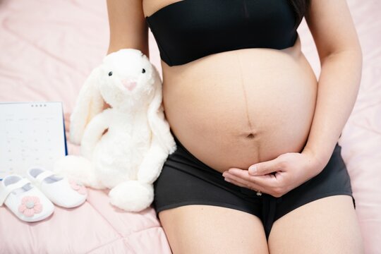 pregnant woman touches belly, Concepts of pregnancy and family. Place for text. Place for your advertisement