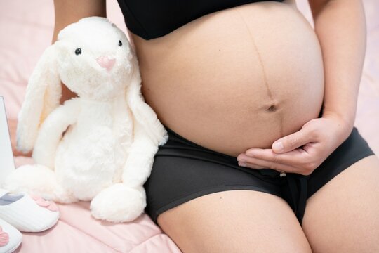 pregnant woman touches belly, Concepts of pregnancy and family. Place for text. Place for your advertisement